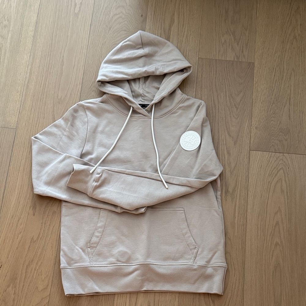Canada Goose Beige hoodie with White Logo Patch on sleeve
